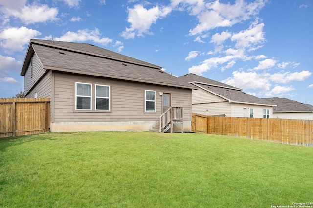 rear view of property with a lawn