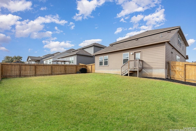 back of property featuring a lawn