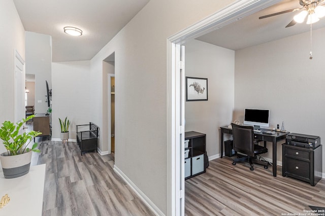 office area with ceiling fan and light wood-type flooring