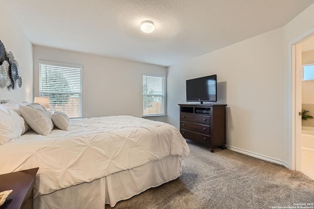 carpeted bedroom featuring a textured ceiling