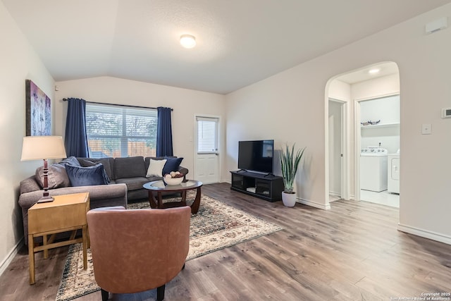 living room featuring lofted ceiling, hardwood / wood-style flooring, and washing machine and clothes dryer