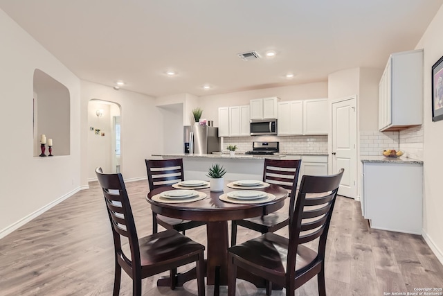 dining area with light hardwood / wood-style floors