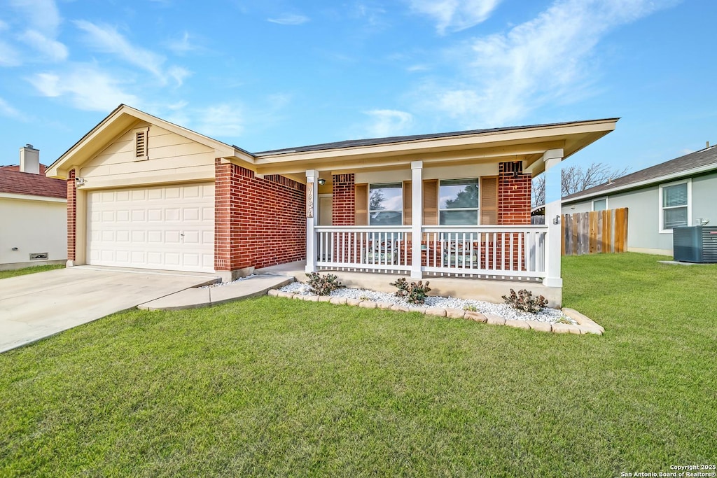 single story home with a garage, a front yard, cooling unit, and covered porch