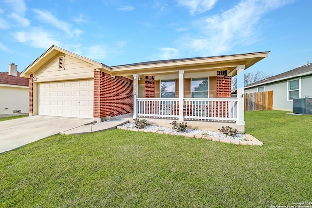 single story home with a garage, a front yard, cooling unit, and covered porch