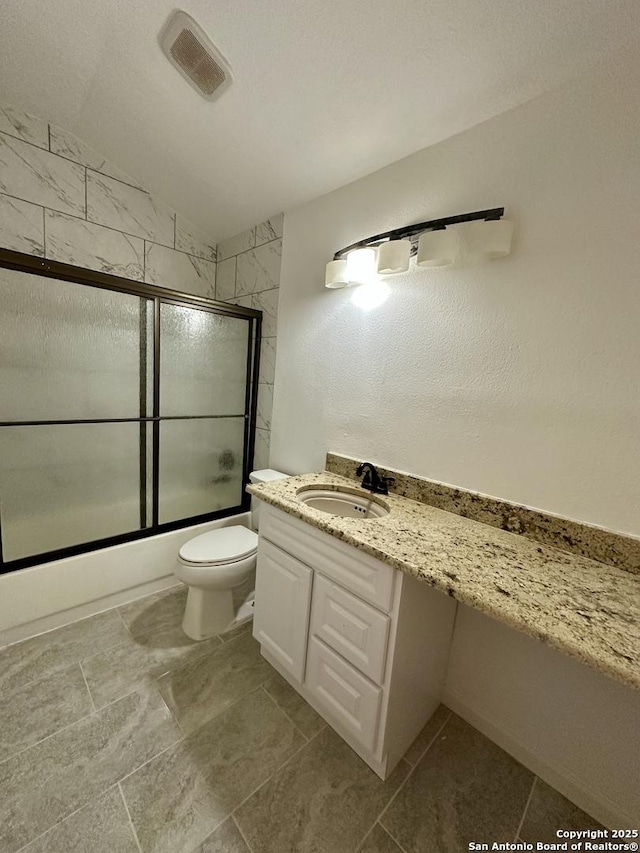 full bathroom with lofted ceiling, vanity, shower / bath combination with glass door, and toilet