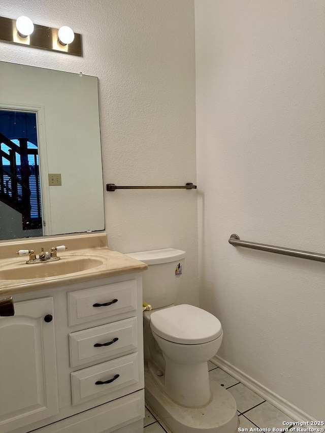 bathroom with vanity, toilet, and tile patterned flooring