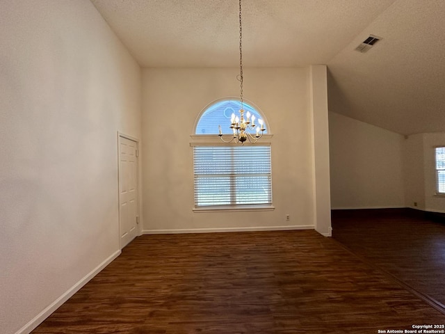 unfurnished dining area with dark hardwood / wood-style flooring, high vaulted ceiling, a textured ceiling, and a notable chandelier