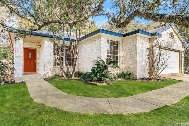 ranch-style home featuring a garage and a front yard