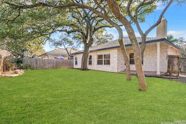 back of property with a lawn