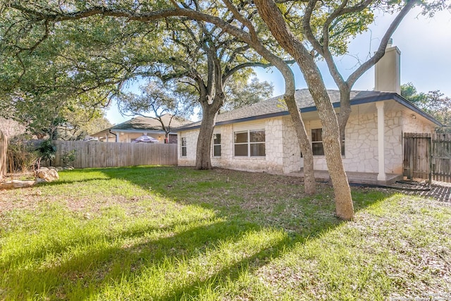 back of property featuring a lawn