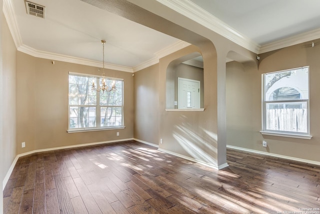 unfurnished dining area featuring dark wood-type flooring, crown molding, and a wealth of natural light