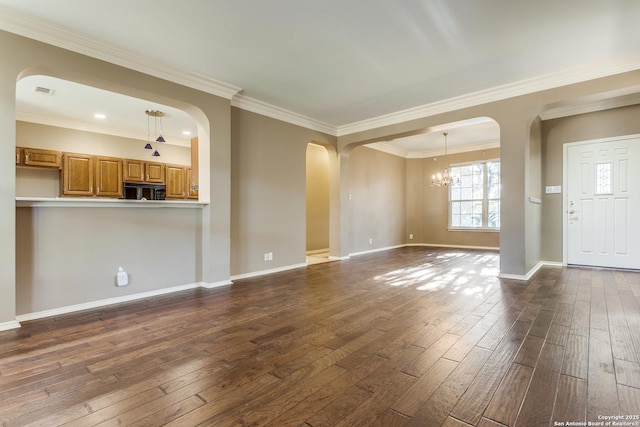unfurnished living room featuring crown molding, dark hardwood / wood-style flooring, and a chandelier