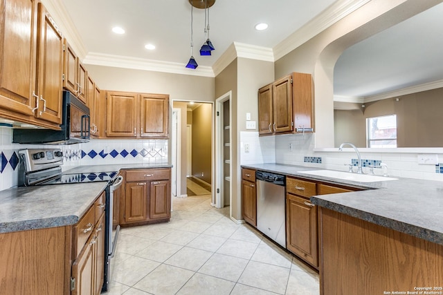 kitchen featuring sink, crown molding, hanging light fixtures, light tile patterned floors, and appliances with stainless steel finishes