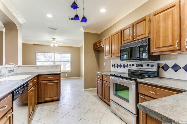 kitchen with sink, crown molding, light tile patterned floors, stainless steel appliances, and decorative light fixtures
