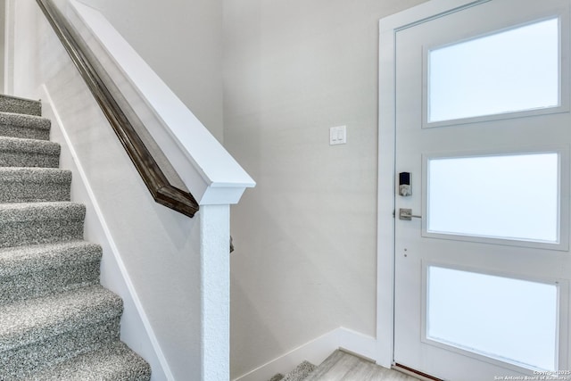 entrance foyer featuring light wood-type flooring and a healthy amount of sunlight