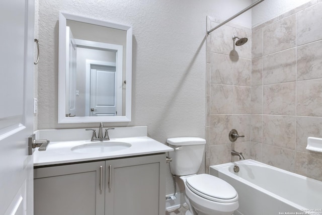 full bathroom featuring toilet, vanity, and tiled shower / bath combo