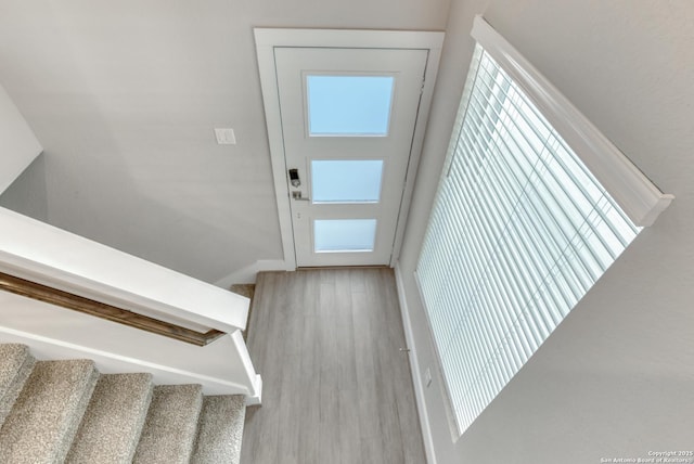 doorway with hardwood / wood-style flooring