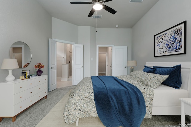 carpeted bedroom with ceiling fan and connected bathroom