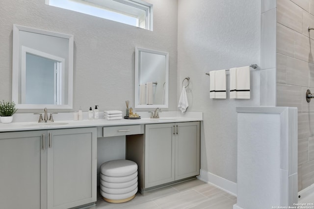 bathroom with vanity and a shower