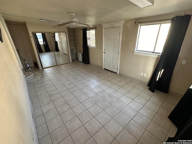 interior space featuring ceiling fan and radiator heating unit