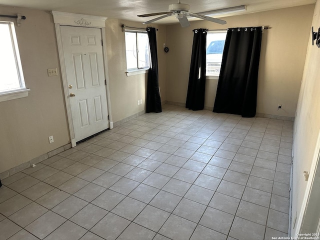 unfurnished room featuring ceiling fan and light tile patterned floors