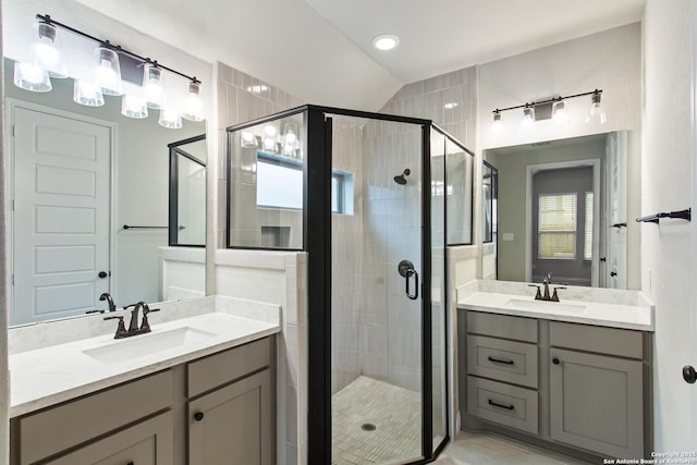 bathroom featuring vanity and a shower with shower door