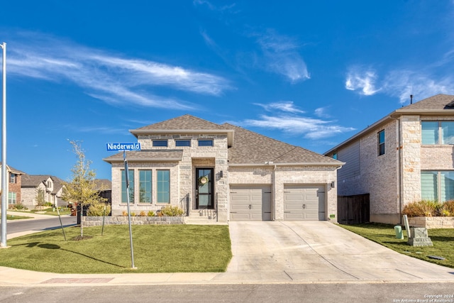 view of front of property featuring a garage and a front lawn