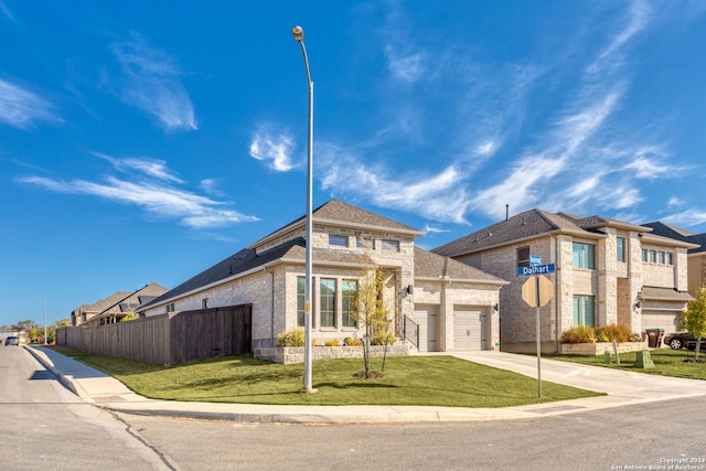 view of front of home with a garage and a front lawn