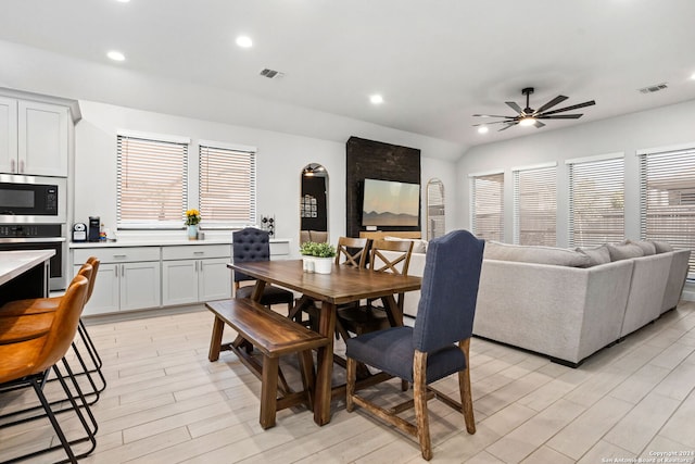 dining space with ceiling fan and light wood-type flooring