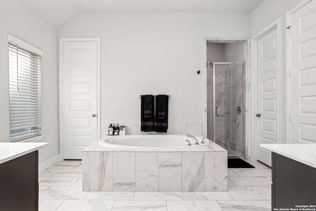 bathroom featuring independent shower and bath, vanity, and lofted ceiling