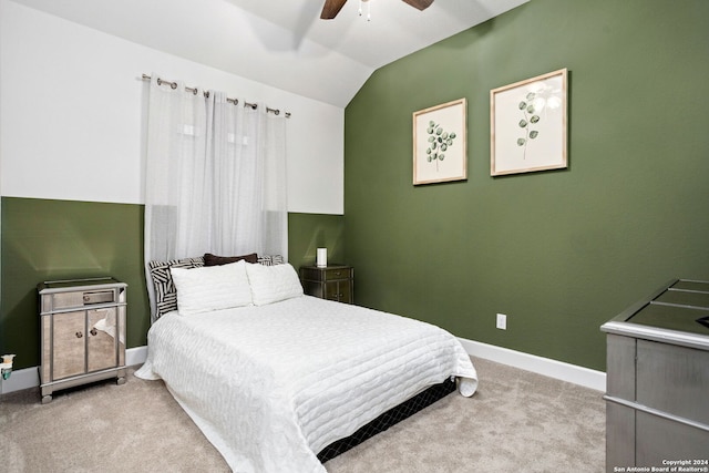 bedroom with light carpet, vaulted ceiling, and ceiling fan