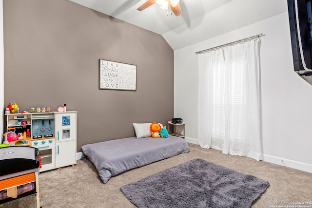 bedroom featuring lofted ceiling, light colored carpet, and ceiling fan