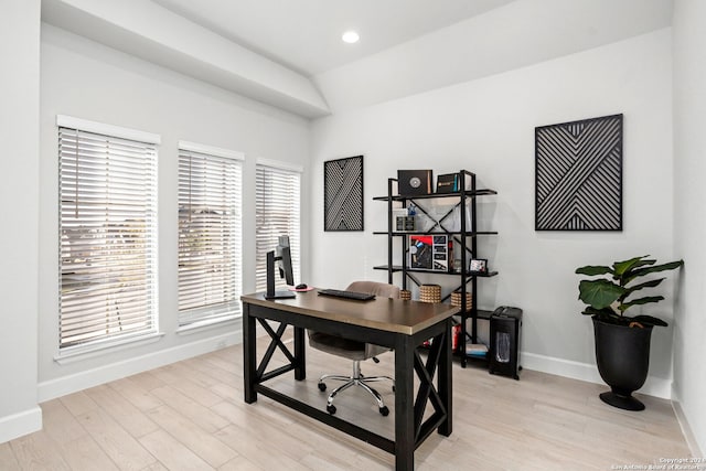 office area featuring vaulted ceiling and light hardwood / wood-style floors