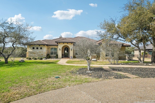 mediterranean / spanish-style home featuring a front lawn