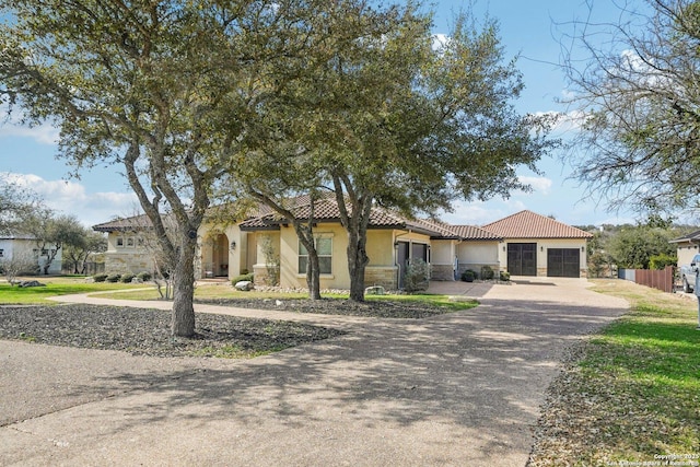 mediterranean / spanish-style house with a garage