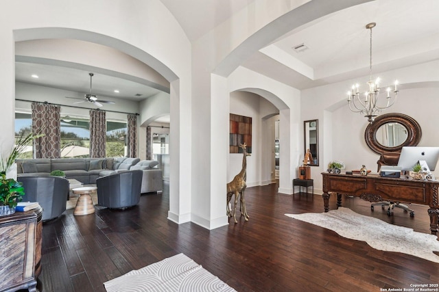 interior space featuring dark hardwood / wood-style floors and ceiling fan with notable chandelier