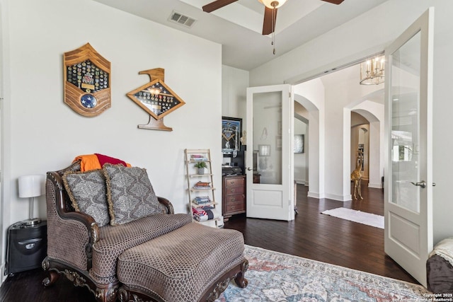 living area with ceiling fan and dark hardwood / wood-style flooring