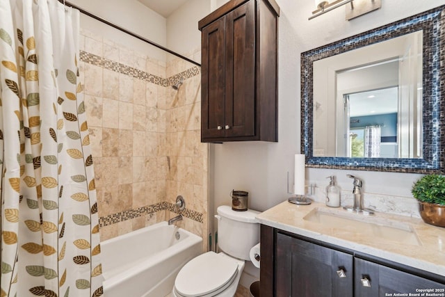 full bathroom with shower / bath combo, vanity, and toilet