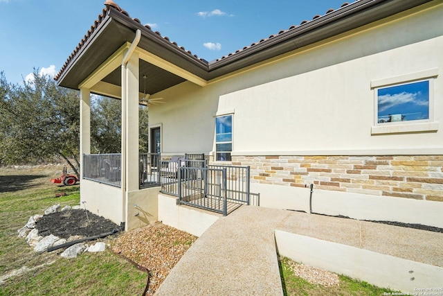 doorway to property featuring ceiling fan and a patio area