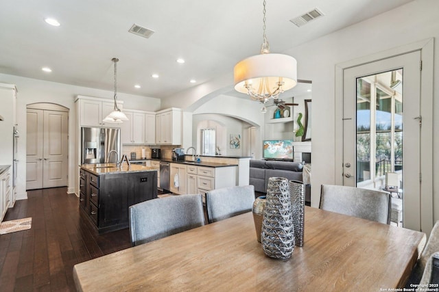 dining area with sink and dark wood-type flooring