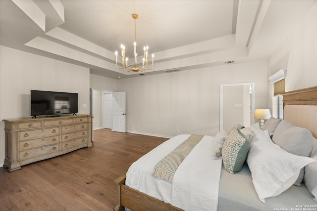 bedroom with visible vents, a tray ceiling, a chandelier, and dark wood-style flooring