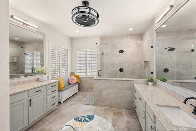 full bath featuring a stall shower, recessed lighting, and vanity