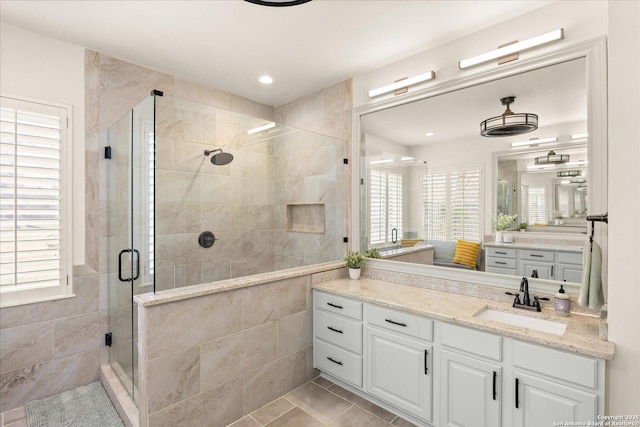 full bathroom with tile patterned flooring, a shower stall, vanity, and recessed lighting