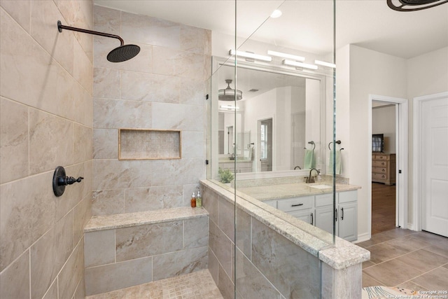 full bath featuring a walk in shower and vanity