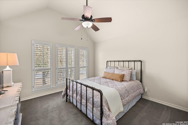 bedroom featuring lofted ceiling, ceiling fan, baseboards, and dark colored carpet