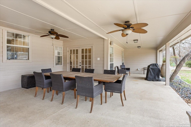 view of patio featuring a grill, outdoor dining area, a ceiling fan, and french doors