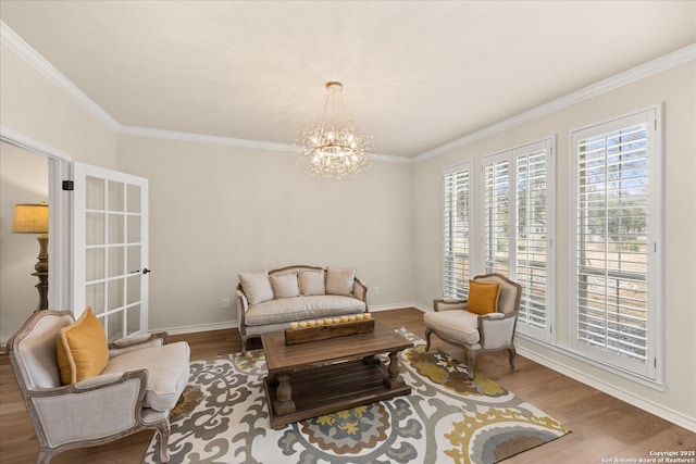 living area with crown molding, baseboards, and wood finished floors