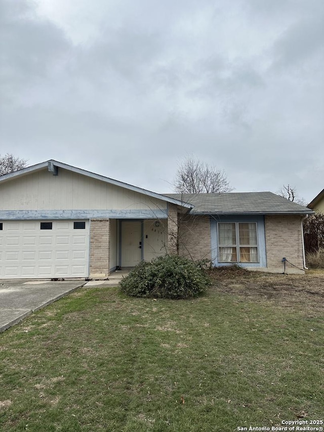 single story home with a garage and a front yard