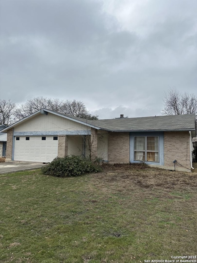 single story home featuring a garage and a front lawn