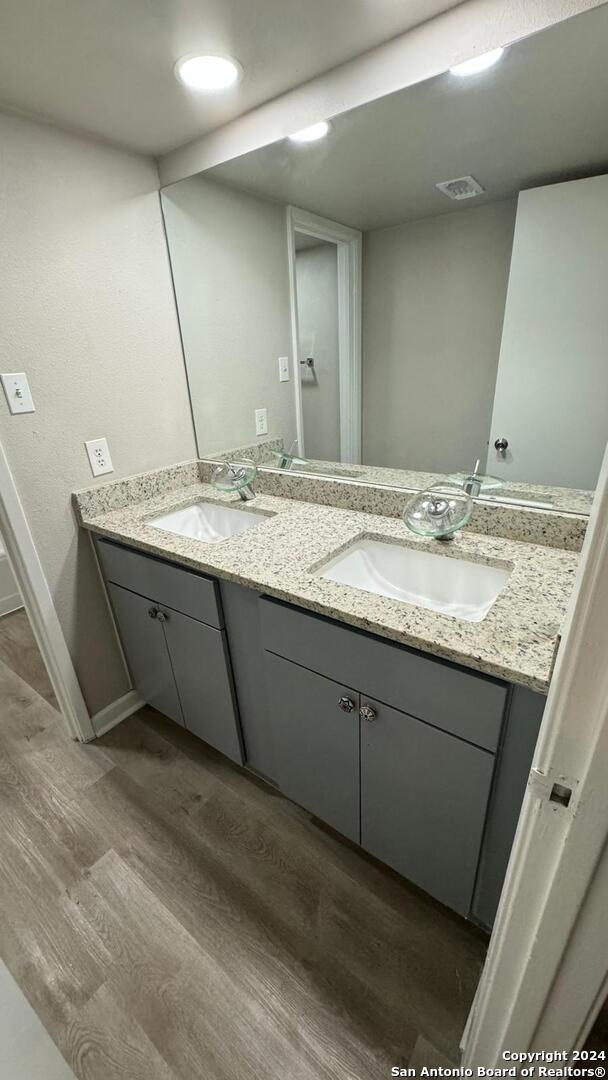 bathroom with vanity and hardwood / wood-style floors